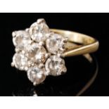 A hallmarked 18ct diamond set daisy cluster ring,