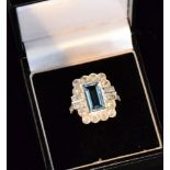 An 18ct white gold aquamarine and diamond cluster ring, central emerald cut aquamarine 3.