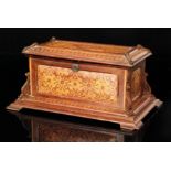 A 19th Century marquetry inlaid casket of floral panel design with carved corner mounts on a