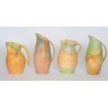 Four assorted 1930s Beswick Art Deco flower jugs of varying form,