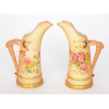 A matched pair of late 19th Century Royal Worcester Tusk form jugs,