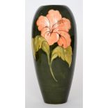 A large Moorcroft Hibiscus pattern vase of tapering form decorated with coral flower heads against