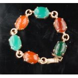 A mid 20th Century yellow metal bracelet set with six claw set agate stones,