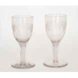 A pair of 19th Century oversized goblets with round funnel bowls engraved with a fruiting vine