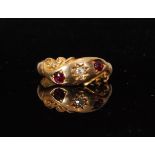 An early 20th Century 18ct hallmarked ruby and diamond three stone ring central diamond flanked by