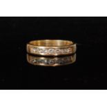 An 18ct hallmarked diamond half eternity ring comprising of seven channel set brilliant cut stones