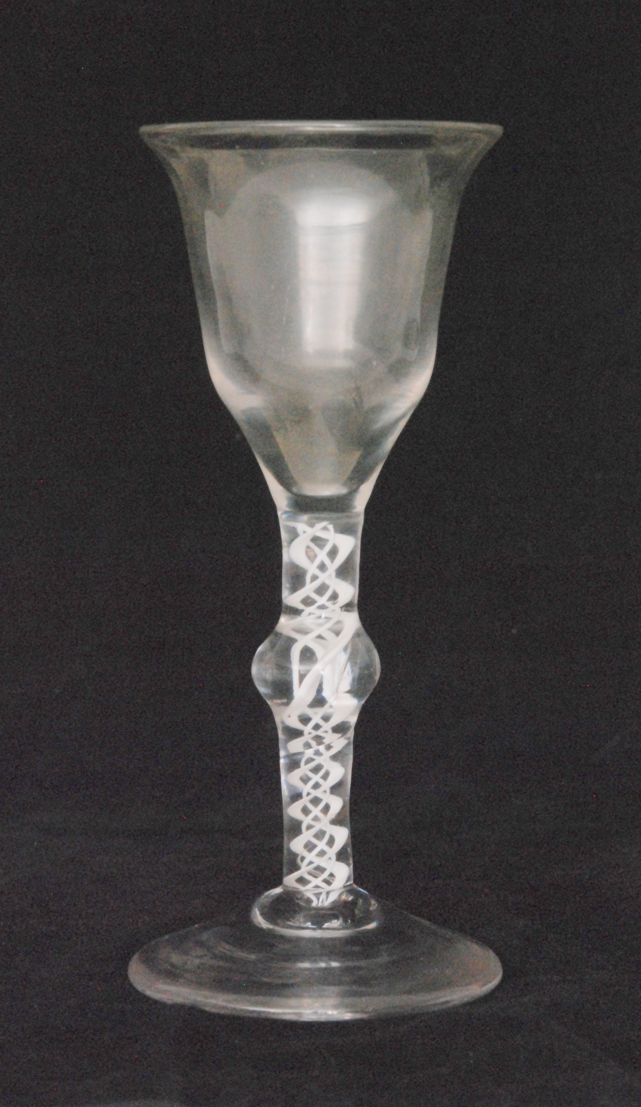 An 18th Century wine glass circa 1760 with a lipped ogee form bowl above a single series opaque