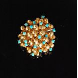 An Italian 18ct and turquoise brooch of circular outline and formed of multiple domed scrolls,