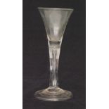 A mid 18th Century drinking glass circa 1740 with trumpet bowl above a plain stem with internal