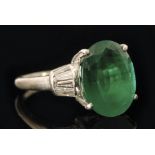 An 18ct white gold emerald and diamond ring, central claw set oval emerald, weight approximately 6.