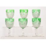 A set of six early 20th Century Stevens & Williams wine glasses with a petal edged radial cut foot