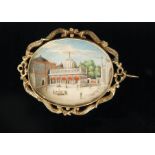 A 19th Century Indian oval miniature watercolour on ivory of an Indian palace with figures seated