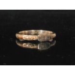 A 19th Century yellow gold coloured mourning band with all over foliate engraved decoration centred