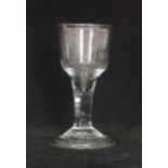 A mid 18th Century wine glass circa 1740 with a drawn ogee form bowl into a plain stem,