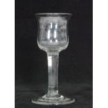 A mid 18th Century wine glass circa 1740 having an ovoid bowl with everted rim above a plain stem