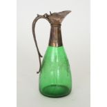 A late 19th Century green glass claret jug of tapered form engraved with a fruiting vine design