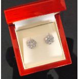 A pair of 18ct white gold diamond daisy cluster stud earrings each comprising of seven claw set