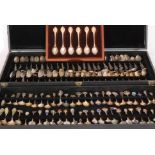 A case containing a approximately 121 silver and low grade silver collectors spoons from across the