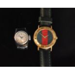 A gold plated Gucci lady's quartz wrist watch with calibrated bezel, red and green banded dial,