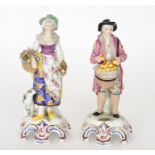 A pair of 19th Century Continental figurines modelled as market sellers,