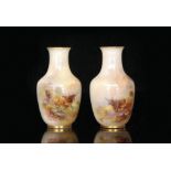 A pair of Royal Worcester baluster vases decorated by Harry Stinton with hand painted facing panel