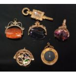 Four 9ct fobs, to include a pierced ball containing three coloured dice,