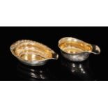 A George III hallmarked silver pap boat, the shaped rim with cast floral border and gilt bowl,