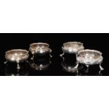 A Victorian hallmarked silver foliate embossed cauldron shaped salt raised on three pad feet,