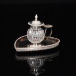 A Victorian tortoiseshell and silver mounted heart shaped inkstand centred by a silver mounted cut