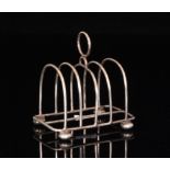 An Edwardian hallmarked silver four division toast rack of plain form with ring handle,