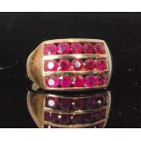 A modern 9ct hallmarked ruby ring comprising of three rows of five channel set rubies to plain