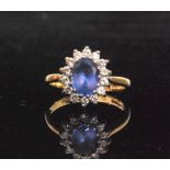 A modern 18ct hallmarked tanzanite and diamond cluster ring,