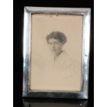 A George V hallmarked silver rectangular photograph frame of plain form with easel stand,