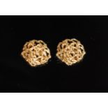 A pair of 1970s abstract yellow gold earrings of circular outline with interwoven strands of gold,