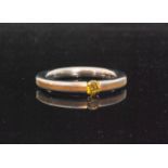 A contemporary platinum natural yellow diamond single stone ring,