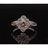 An 18ct white gold diamond cluster ring comprising of nine collar set brilliant cut stones flanked
