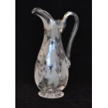 A 19th Century clear crystal claret jug of footed swollen ovoid form with slender waisted neck,