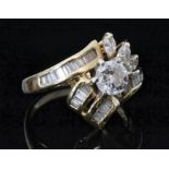 A 14ct hallmarked abstract diamond cluster ring, central high set brilliant cut diamond,
