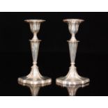 A pair of late Victorian hallmarked silver candlesticks, each with knopped and faceted capital,