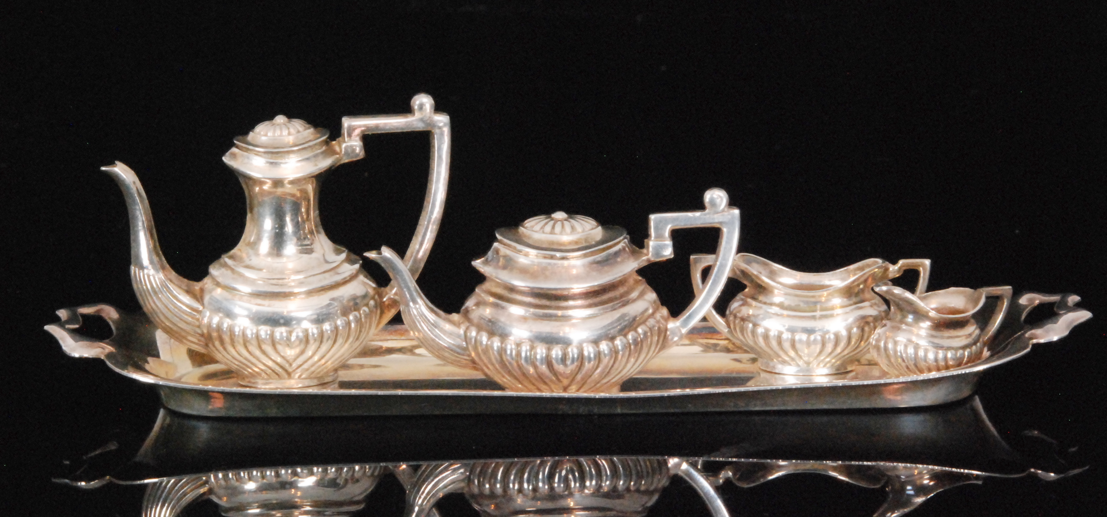 A late 20th Century hallmarked silver miniature four piece tea set,