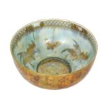 A large 1920s Wedgwood lustre bowl of footed circular form decorated with gilt moths and