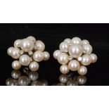 A pair of diamond and pearl earrings designed as a flowerhead cluster of thirteen graduated pearls,