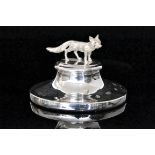 A modern hallmarked silver paperweight, the circular base mounted with a model of a fox,