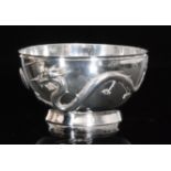 A Chinese silver rose bowl with cast decoration of two scrolling dragons chasing a pearl on