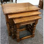 A nest of three oak occasional tables on bobbin turned legs,