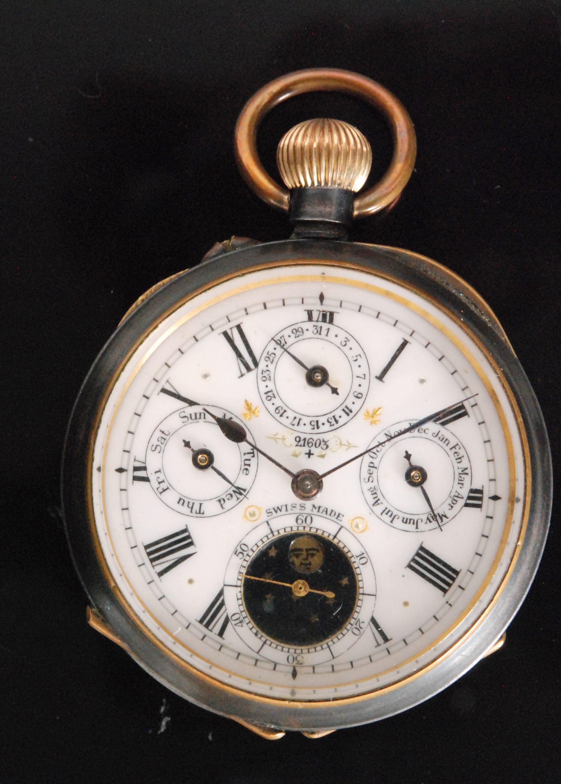 An early 20th Century gun metal Swiss open faced, crown wind, calendar pocket watch,