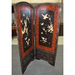 A 20th Century Japanese shibyama two fold dressing screen decorated with flying birds in a carved