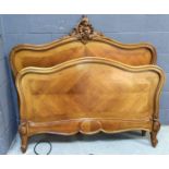 A pair of 20th Century French carved walnut bed ends mounted with a scroll pediment together with