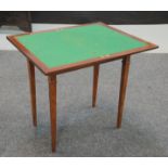 An early 20th Century mahogany rectangular fold over card table green baize lined interior on