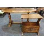 A 17th Century style oak oval occasional table on turned legs united by a rail stretcher,